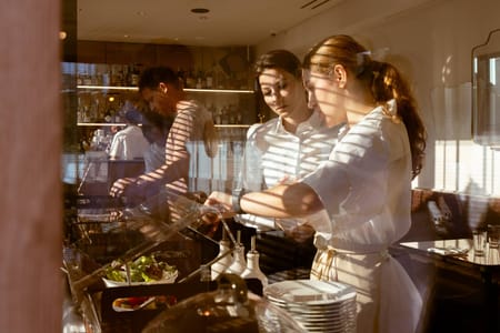 Hotel staff and guests at the breakfast buffet, Hotel Calimala Milan