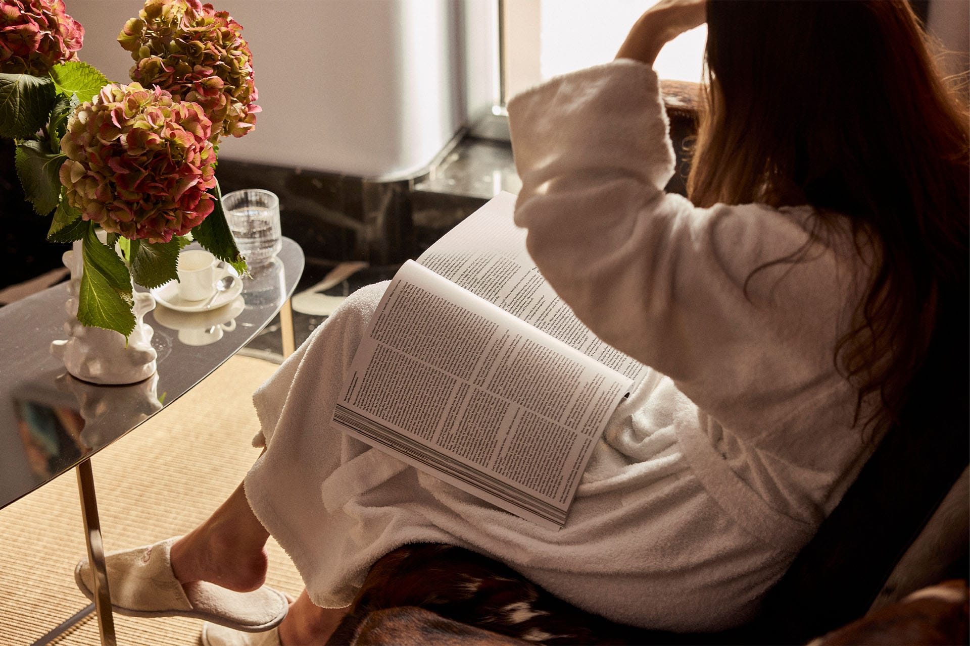 Girl reading the newspaper in a bathrobe